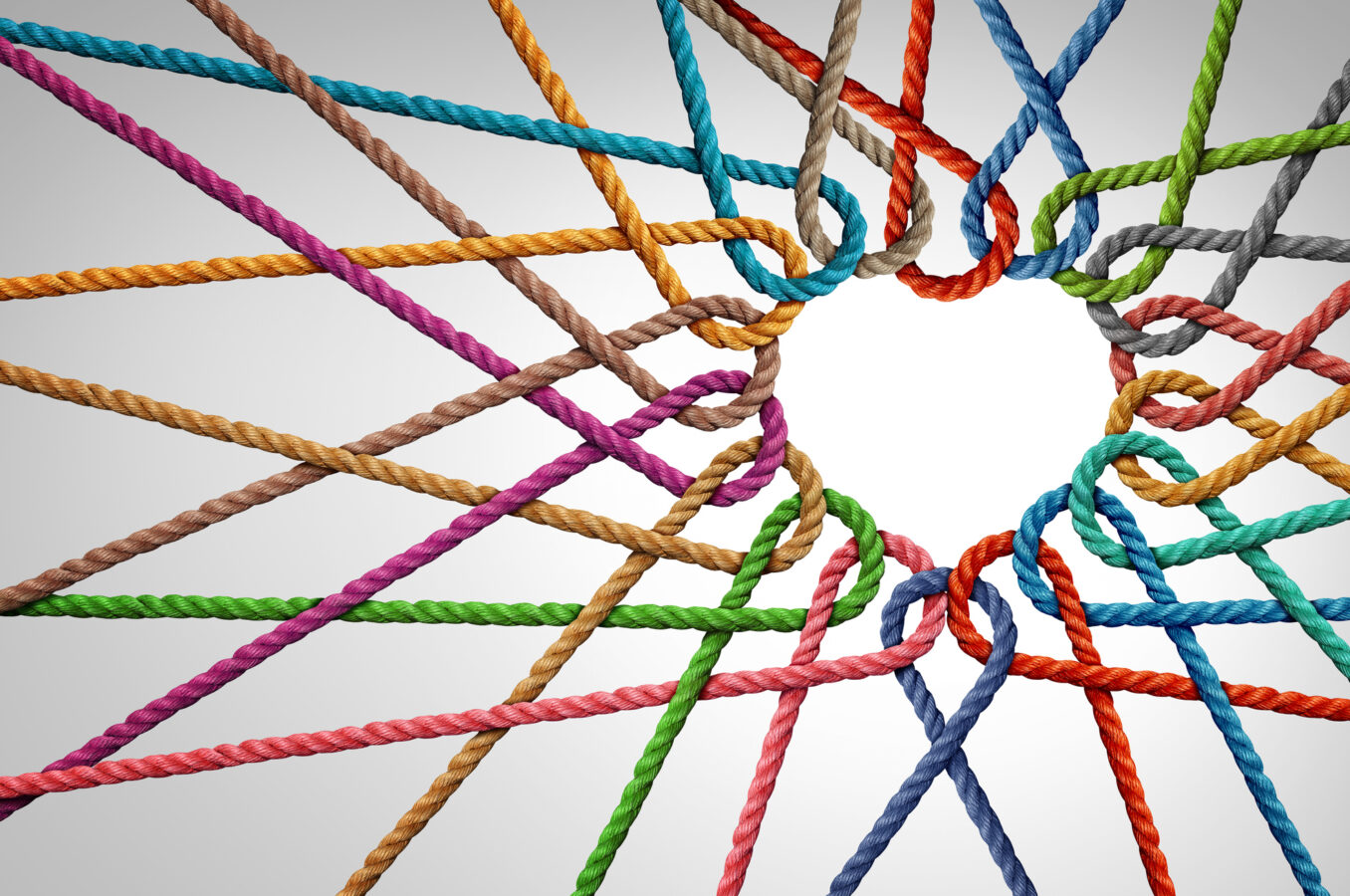 Colored threads woven into a heart shape.
